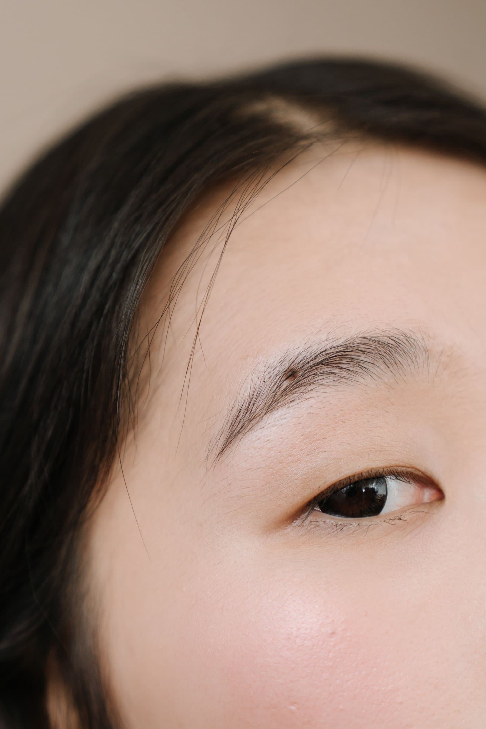 Natural brow and skin texture in close editorial light