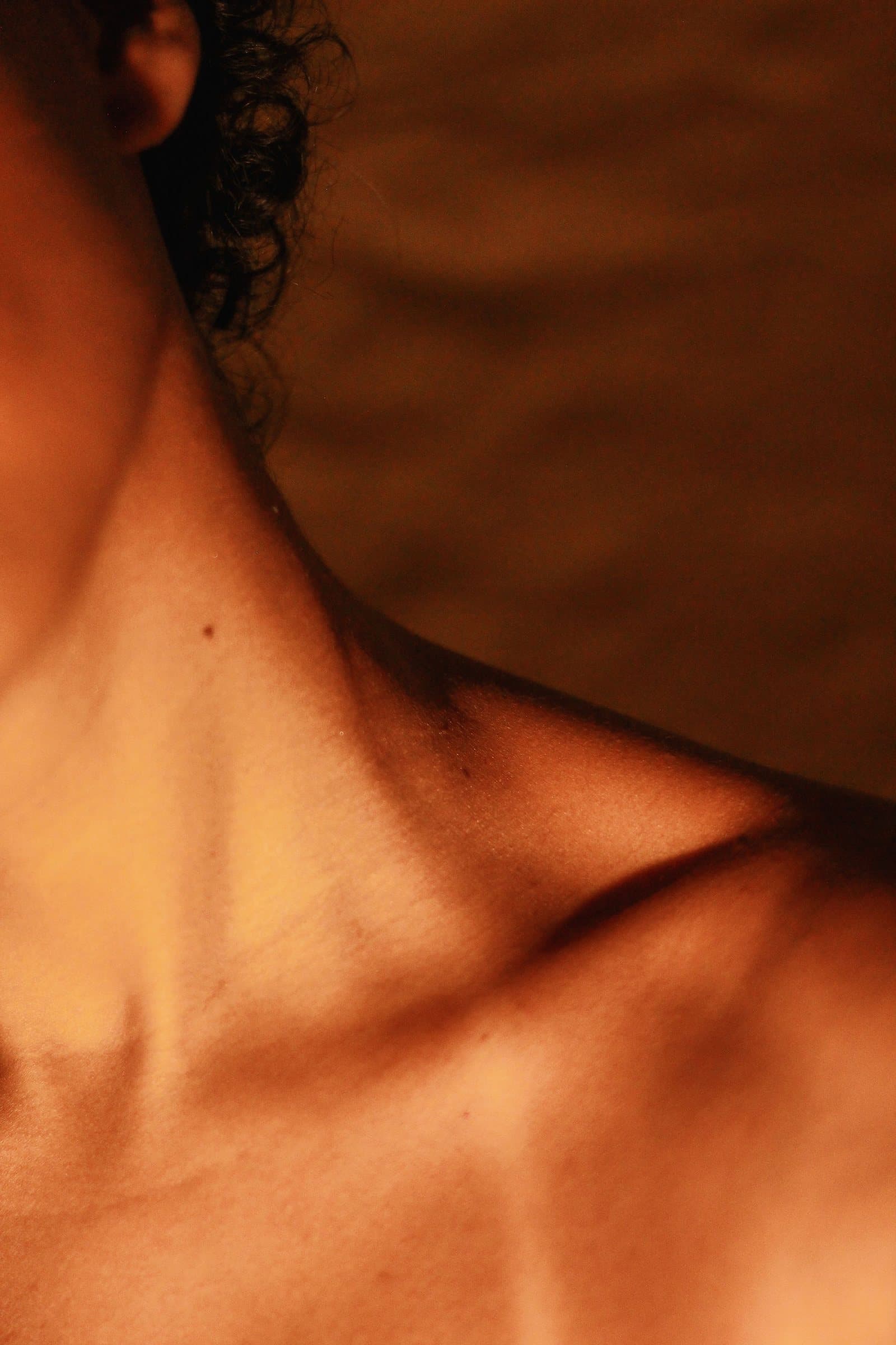 Natural collarbone and skin photographed in warm light