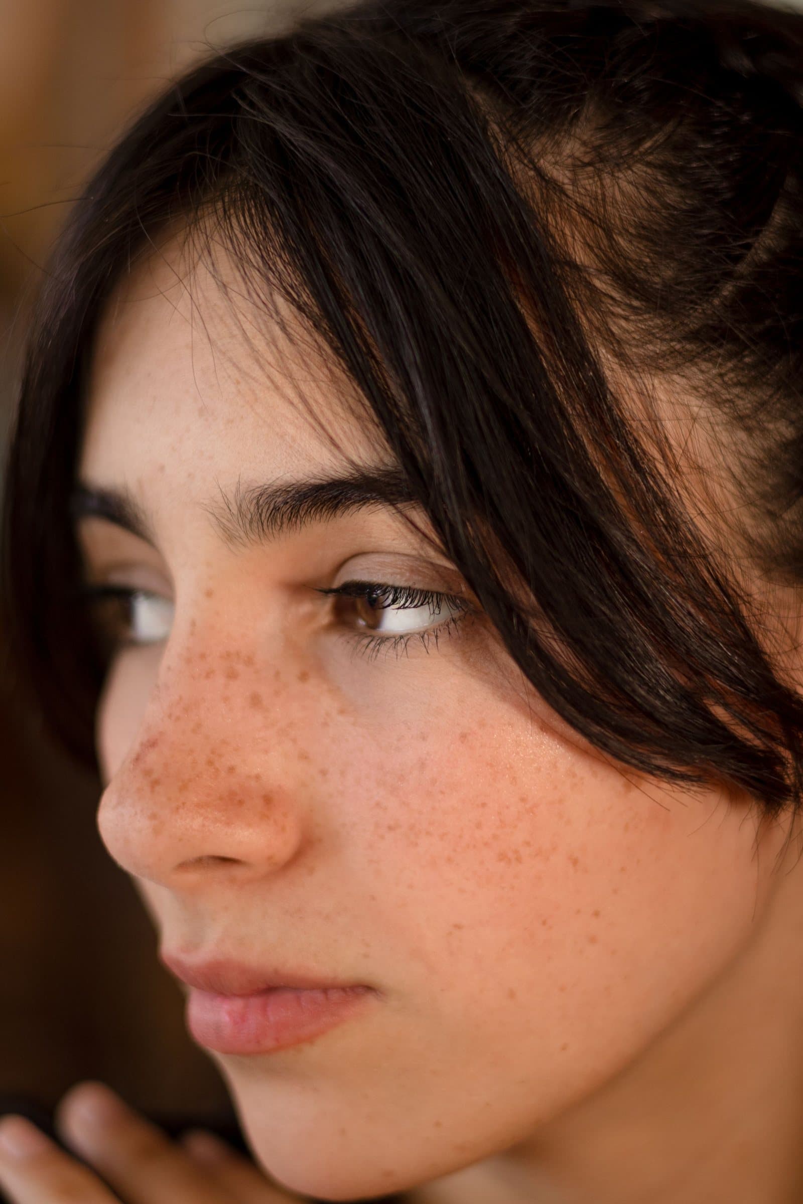 Natural skin with visible texture and freckles